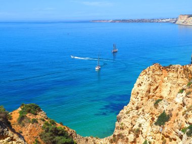 Hiking from Ponta da Piedade to beach Praia do Porto de Mos in Lagos at the beautiful portuguese Algarve coast clipart