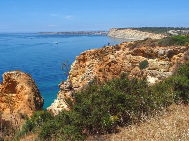 Hiking from Ponta da Piedade to beach Praia do Porto de Mos in Lagos at the beautiful portuguese Algarve coast clipart