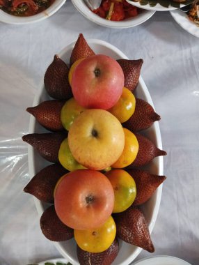 A Bowl of Fresh Fruit with Apples, Oranges, and Salak clipart