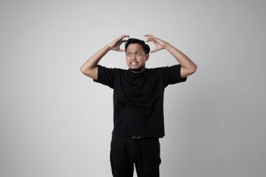 Öfkeli genç adamların öfkeli bir hareketle el ele tutuşmalarının portresi. Siyah tişörtlü genç adamlar. Negatif insan duyguları ve yüz ifadeleri..