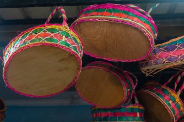 A hand-woven rattan fruit basket hung by a fruit vendor that is usually used to store fruits, parcels, gifts, or souvenirs clipart