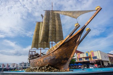 Tanjungpinang, Indonesia - December 28, 2024: This Lancang Kuning-shaped iron sculpture is a traditional Malay ship with a history dating back to the pre-colonial era. This ship was used for trading clipart