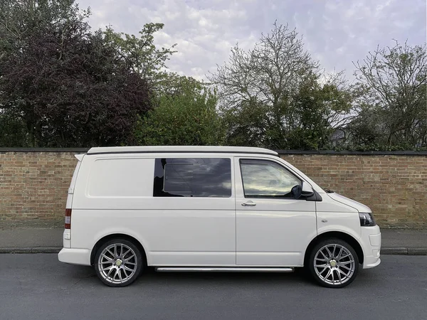stock image St Neots, UK - April 24th 2021: Side view of a VW Camper Van parked infant of a brick wall. High quality photo