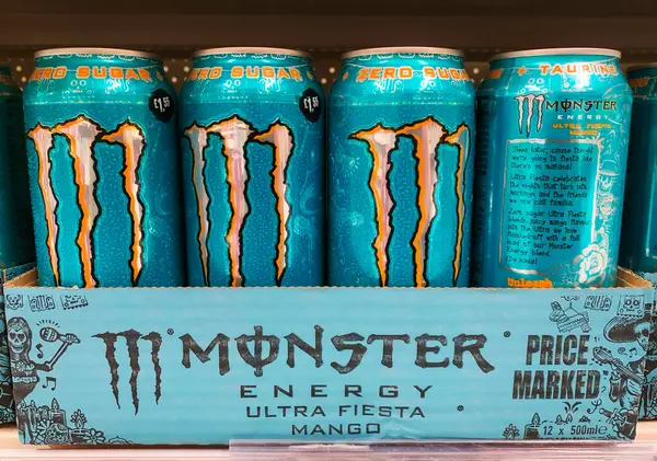 stock image St Neots, UK - Saturday 15th June 2024: Cans of Monster Energy ultra fiesta mango drink on a store shelf. High quality photo