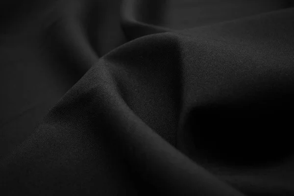 深色黑色面料的纹理特写 低调的照片丛螺纹 服装业 摘要背景 黑色的纺织品波浪黑布背景 — 图库照片