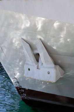 White anchor on a white ship. Shipping. Sea port. Freight and passenger transportation.