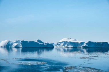 Antarctic landscape featuring icebergs on a bright sunny day during summer by the east coast of the Antarctic Peninsula, Antarctica clipart