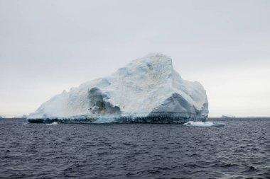 Large mountain-shaped iceberg melting in the Weddell Sea near the Seymour Island, Graham Land, Antarctica clipart