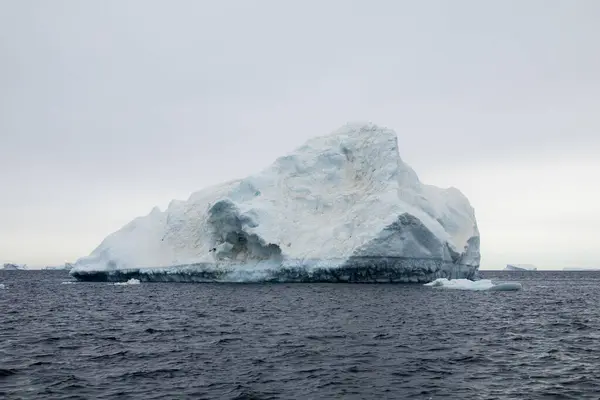 Melting iceberg covered with dust and soot spots, floating east of the Antarctic Peninsula, Antarctica