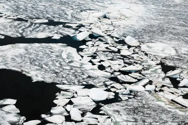 Sea ice breaking off the ice shelf of the Antarctic Peninsula, Antarctica, aerial view