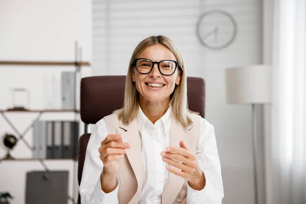 stock image Smiling mid aged business woman looking at web cam video conference calling in virtual chat meeting, giving remote training webinar class working from home office. Headshot face portrait. Webcam view