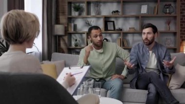 LGBT family at a psychotherapists appointment. A family psychologist conducts a session in a beautiful office. Psychologist for gay. Support for the LGBT community on a visit to a psychologist
