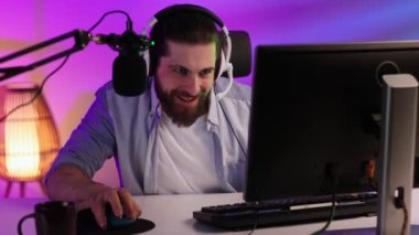 Close-up portrait of an esportsman. A professional gamer plays a computer video game, communicates in a headset with a team at the E-Sport championship. cyber gaming arena
