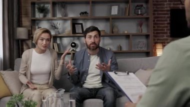 A quarrel between a husband and wife at a psychotherapists appointment. A visit to a family psychologist for a married couple. An African-American doctor consults an unhappy couple