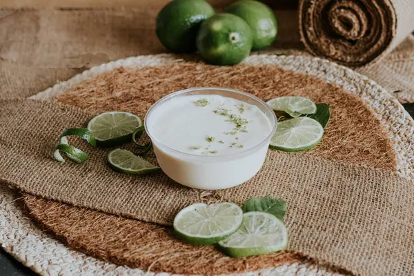 homemade coconut yogurt with fresh lime, lime and mint leaves