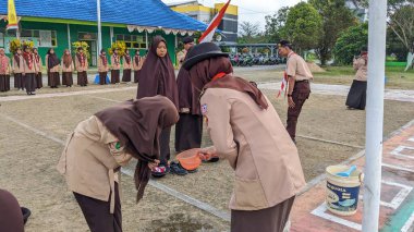 Okul bahçesinde izci çocukların açılış töreni.