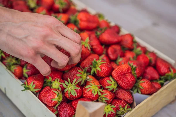 stock image Strawberry box placed on a wooden table, healthy living concept.