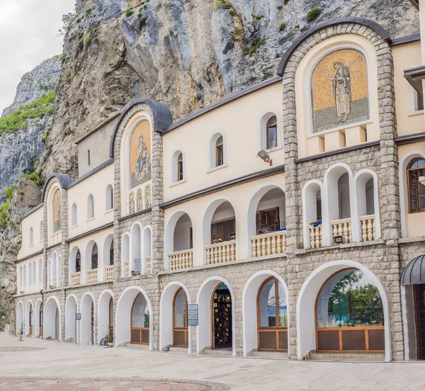 stock image Monastery of Ostrog, Serbian Orthodox Church situated against a vertical background, high up in the large rock of Ostroska Greda, Montenegro. Dedicated to Saint Basil of Ostrog.