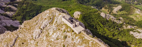 stock image BANNER, LONG FORMAT Montenegro. Lovcen National Park. Mausoleum of Negosh on Mount Lovcen. Drone. Aerial view. Viewpoint. Popular tourist attraction. Petar II Petrovic-Njegos mausoleum on the top of