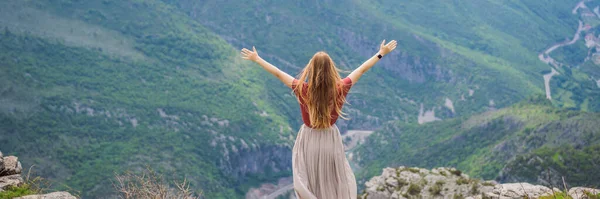 stock image BANNER, LONG FORMAT Woman tourist on background of Blue river running through green valley toward distant mountains. Beautiful mountains of Montenegro and the river Cievna.