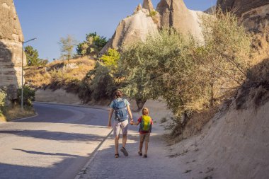 Baba ve oğul turistler Kapadokya 'daki Sevgi Vadisi' nde eşsiz jeolojik oluşumların arka planında, Türkiye 'de popüler seyahat merkezleri. Türkiye konseptinde çocuklarla seyahat.
