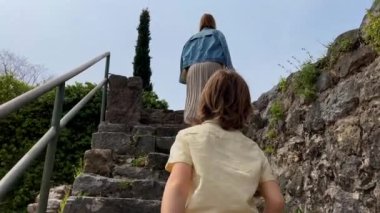 Slowmotion video. A young woman and her son visit the ruins of the Bar old city or Stari Grad. A destroyed ancient settlement close to the city of Bar. Travel destinations of Montenegro.