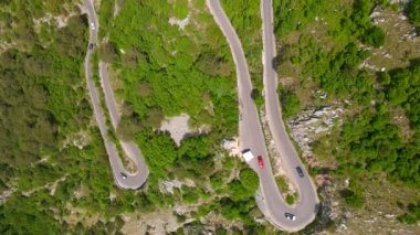 Bu stok videosunda Karadağ 'daki Kotor-Cetinje yılanının çarpıcı hava manzarası sergileniyor. Engebeli dağ manzarasının içinden geçen dolambaçlı yol gerçekten görülmeye değer bir manzara. Yakalandı.