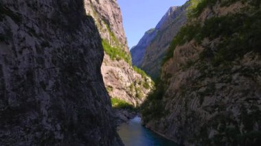 Aerial video of the stunning Moracha River canyon in Montenegro. Soar above the magnificent natural scenery, capturing stunning aerial views of the towering cliffs, crystal-clear river, and lush