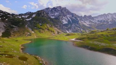 This stunning drone shot captures the breathtaking beauty of Durmitor National Park in the northern part of Montenegro. The aerial view, captured by a drone, offers a breathtaking perspective on the