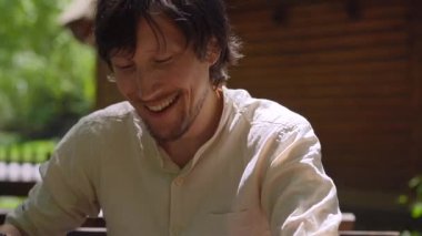 In this stock video, a young man sits down to enjoy a traditional Montenegrin or Balkan dish known as kajmak or Kacamak. The dish is a creamy blend of cheese, potato and cornmeal, and is a staple of