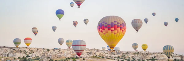 カラフルな熱気球がトルコのカッパドキア上空を飛んでいます バナー ロングフォーマット — ストック写真