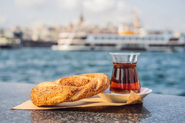 İstanbul, Türkiye 'de altın boynuz körfezine karşı bir bardak Türk çayı ve simit. Türkiye.