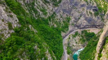Aerial video of the stunning Moracha River canyon in Montenegro. Soar above the magnificent natural scenery, capturing stunning aerial views of the towering cliffs, crystal-clear river, and lush