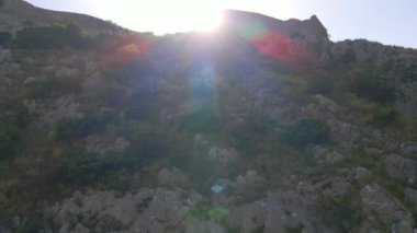 This aerial stock video captures the stunning ruins of the Old Bar or Stari Bar, a historical landmark in Montenegro. The drone footage showcases a birds eye view of a stone fortress and an aqueduct