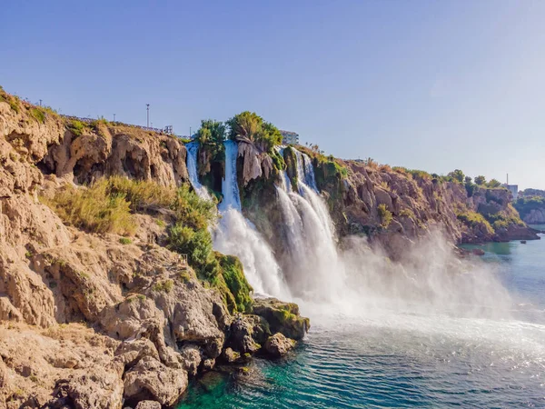 stock image Lower Duden Falls drop off a rocky cliff falling from about 40 m into the Mediterranean Sea in amazing water clouds. Tourism and travel destination photo in Antalya, Turkey. Turkiye