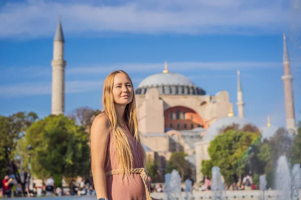 stock image Woman enjoy beautiful view on Hagia Sophia Cathedral, famous islamic Landmark mosque, Travel to Istanbul, Turkey. Sunny day architecture and Hagia Sophia Museum, in Eminonu, istanbul, Turkey. Turkiye.