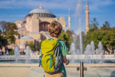 Erkek Turist, Ayasofya Katedrali 'nin, ünlü İslami Tarihi Cami' nin, İstanbul 'a Seyahatin tadını çıkarıyor. Çocuk konseptiyle seyahat etmek. Güneşli gün mimarisi ve Ayasofya Müzesi
