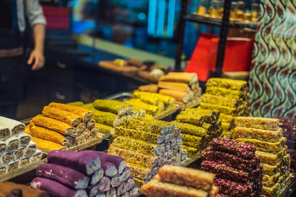 Traditional oriental sweet pastry cookies, nuts, dried fruits, pastilles, marmalade, Turkish desert with sugar, honey and pistachio, in display at a street food market.