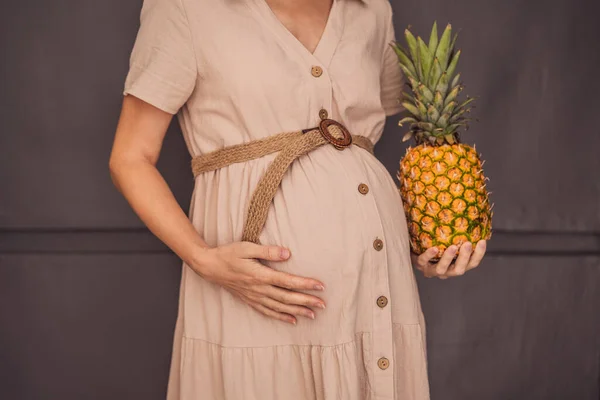 임산부의 아름답게 그녀의 아기의 크기를 보여주는 파인애플과 비슷한 임신과 파인애플의 — 스톡 사진