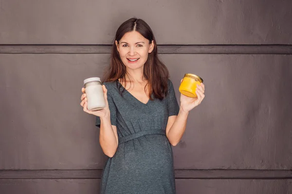 A glowing pregnant woman over 40, savoring nourishing ghee and coconut oil for a healthy and vibrant pregnancy journey.
