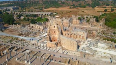 Bu büyüleyici havacılık videosunda, Türkiye 'nin Antalya kentindeki antik Perge kentinin dikkate değer kalıntıları gösteriliyor. Kamera zarif bir şekilde yukarıda süzülüyor, bir panoramik sunuyor.
