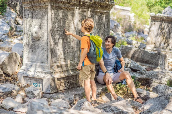 Father and son tourists explores Stunning Ancient Theater of Termessos Ancient City. Traveling with kids concept. turkiye, GO Everywhere.