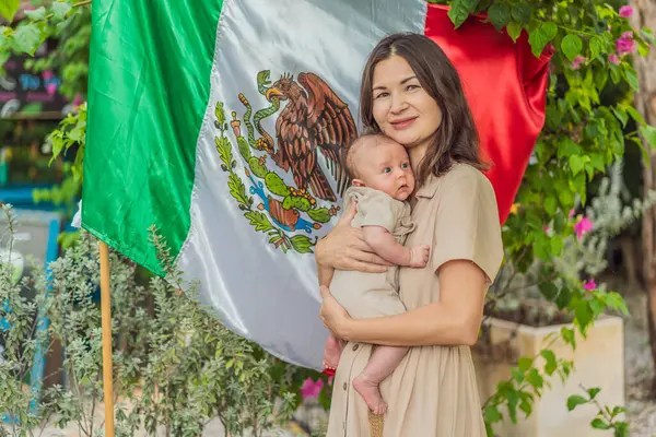 Immigrant family in front of the Mexican flag. New Mexicans. Childbirth in Mexico.