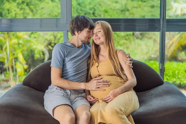 Tender Moment Captured Husband Pregnant Wife Sit Sofa Sharing Affectionate — Stock Photo, Image