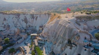 Goreme, Cappadocia, Türkiye 'nin bu büyüleyici klibiyle görsel deneyimlerinizi artırın. Goreme tepesinin tepesinde Türk cumhuriyetine ait el sallayan bir bayrak bulunmaktadır. Şey...