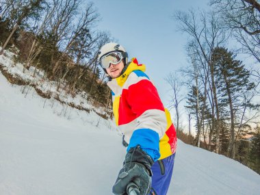 Cesur bir adam, kar yamaçlarını ustalıkla fetheder. Snowboard 'da manevra yaparken yeteneğini ve heyecanını gösterir. Kış macerasının özünü yakalar..