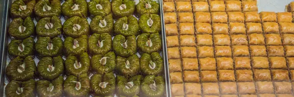 BANNER, LONG FORMAT Traditional oriental sweet pastry cookies, nuts, dried fruits, pastilles, marmalade, Turkish desert with sugar, honey and pistachio, in display at a street food market.