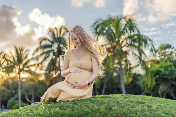 妊娠中の女性としてのトランキルシーンは 公園で平和な瞬間を楽しんで 自然の静けさを受け入れ 妊娠中に快適さを見つける — ストック写真