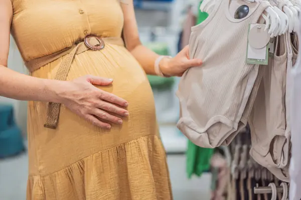 Expectant Mother Joyfully Selects Adorable Clothes Her Unborn Baby While — Stock Photo, Image