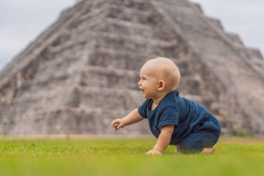 Baby traveler, tourists observing the old pyramid and temple of the castle of the Mayan architecture known as Chichen Itza. These are the ruins of this ancient pre-columbian civilization and part of clipart